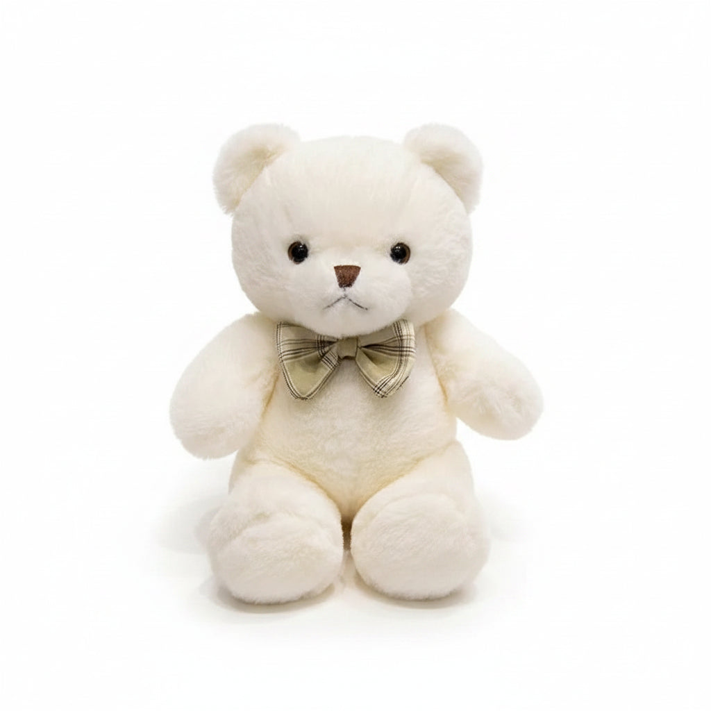 Ours en peluche blanc avec un nœud doré, assis sur fond blanc