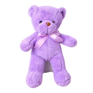 Peluche ours violette avec un ruban en satin, sur fond blanc